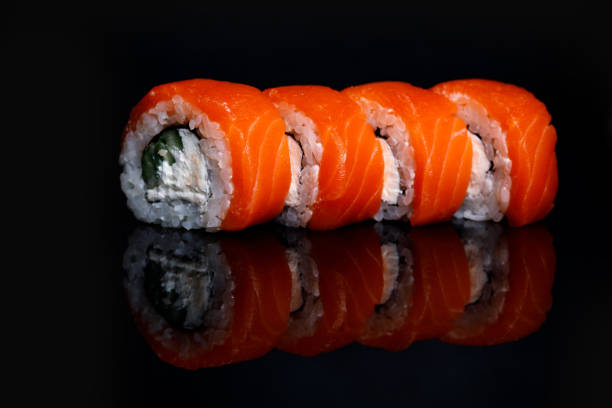 istock Philadelphia Sushi Roll on a black background with reflection. 1217478547