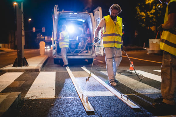 istock Transportation Maintenance Crew Repainting Zebra Crossing 1217480460