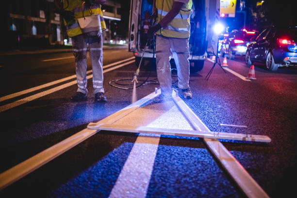 istock Road Surface Painting Crew Working on Urban Arrow Marking 1217480464