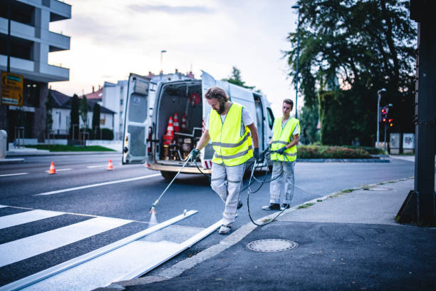 istock Pavement Marking Crew Repainting Zebra Crossing at Dusk 1217480471