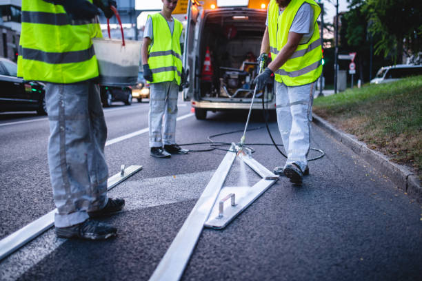 istock Transportation Crew Repainting Turn Arrow Marking at Dusk 1217480492