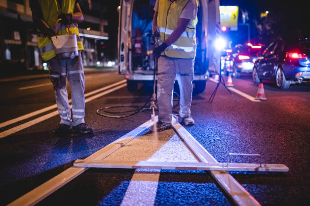 istock Nighttime Transportation Crew Repainting Arrow Marking 1217480498