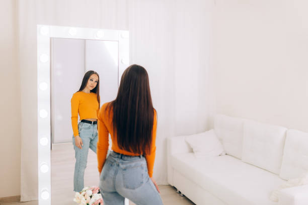 istock girl standing in front of mirror 1217480747