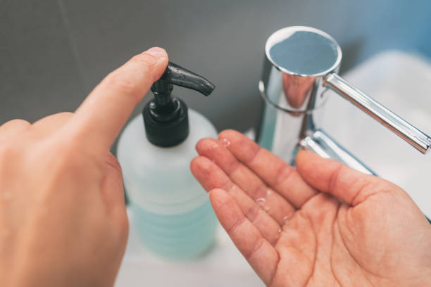 istock Washing hands with soap how to wash step 2 : squirt liquid from soap bottle dispenser for rubbing hands together 1217481081