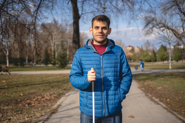 istock Independent young blind person with a walking cane 1217483043