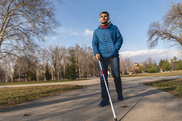 istock Young man with visual impairment enjoying a walk on a warm day 1217483795