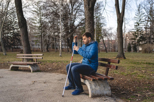 istock Young man with visual impairment relaxing on a park bench 1217483840