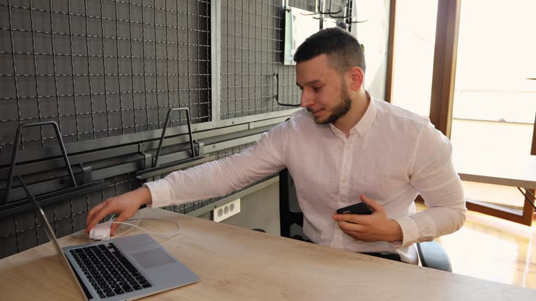 Businessman interrupts a conversation to charge his smart phone because his battery is running low