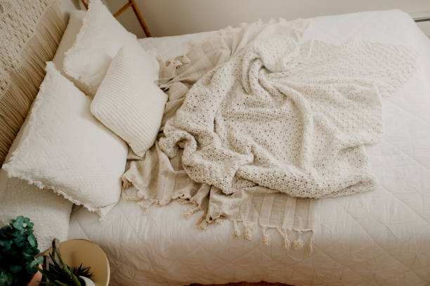 istock Queen Bed Layered with Neutral Duvet and Comfy Throw Blankets 1217491042