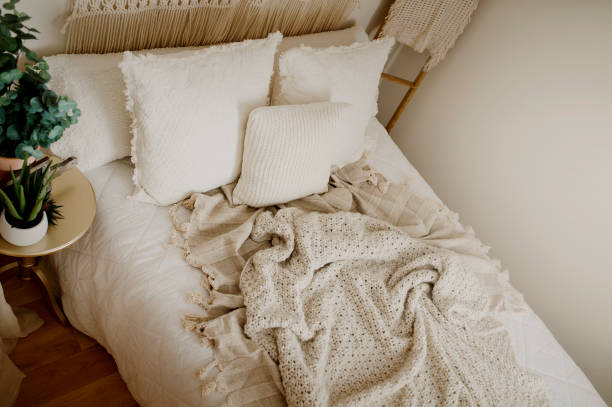 istock Queen Bed Layered with Neutral Duvet and Comfy Throw Blankets 1217491045