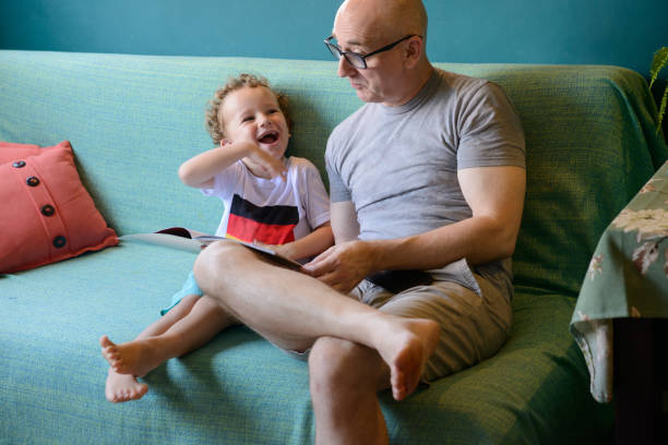 istock Happy toddler laughing bonding with uncle 1217500403