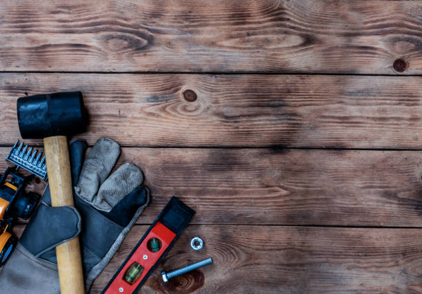 istock Labor day concept on wood background. Engineer and worker tools with construction safety equipment and mask. Safety first concepts 1217505014