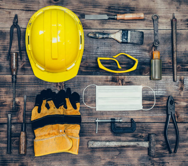 istock Labor day concept on wood background. Engineer and worker tools with construction safety equipment and mask. Safety first concepts 1217505022
