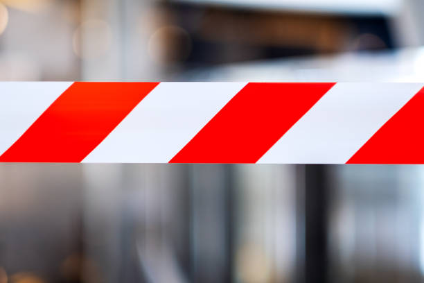 istock Red and white warning tape stretched across danger area 1217505120