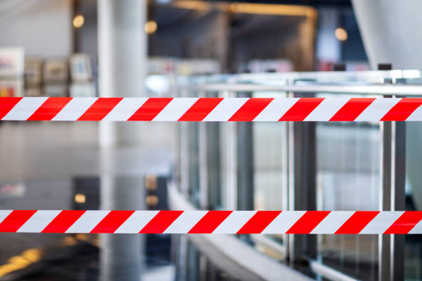 istock Red and white warning tape stretched across danger area 1217505136