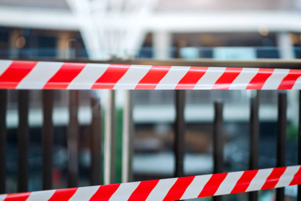 istock Red and white warning tape stretched across danger area 1217505138