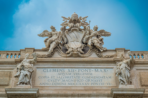 The inscriptions are homage to the popes involved in the construction. And the Trevi Fountain is crowned with the coat of arms of Pope Clement XII