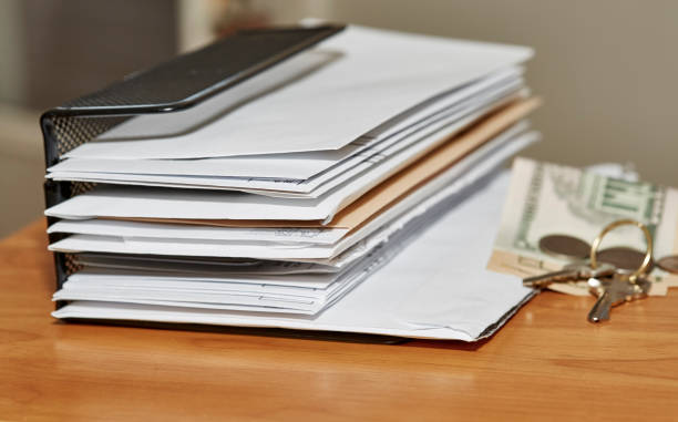 istock Paper Envelopes with Keys and Money on a Desk 1217508408