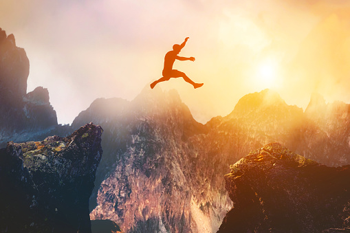 Man jumping between rocks. Overcome a problem, challenge, and hope for a better future. 3D illustration