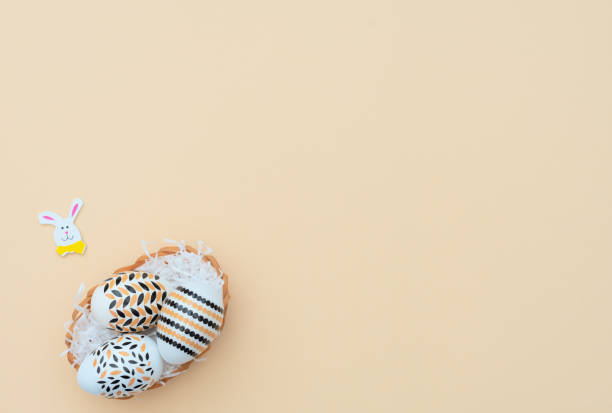 istock Decorated Easter eggs lie in the basket on yellow background with Easter bunny. Happy Easter holiday concept. Greeting, invitation card. Flat lay style with copy space. 1217513340