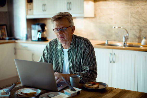 istock Mature man working from home 1217513693