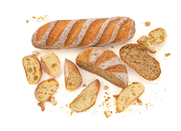 istock Sliced Multigrain rustic  bread isolated on a white background. Rye Bread with crusty loaves and crumbs. Top view. Flat lay. Bakery Food concept. 1217514627
