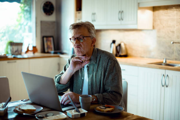 istock Mature man working from home 1217515609