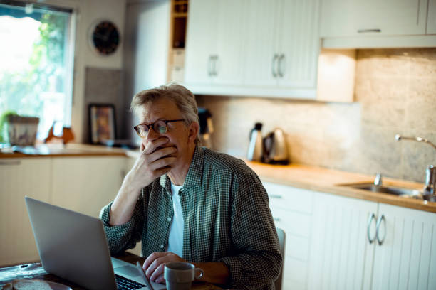istock Mature man working from home 1217516142