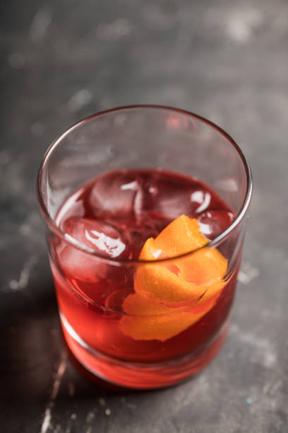 istock Red traditional old fashioned cocktail with orange zest on the rustic background 1217517672