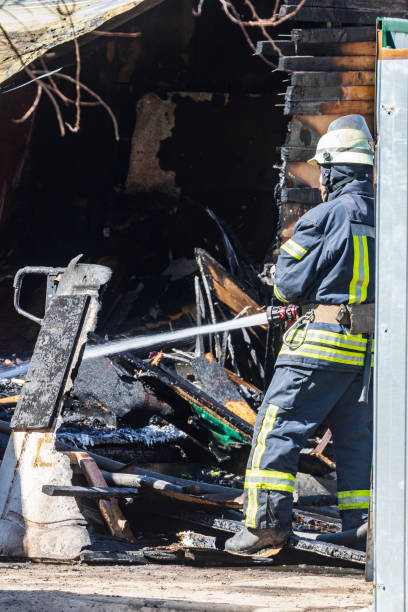 istock A strong and brave fireman rescues a burning building using water in a fire operation. Fireman in a fire protection suit. 1217517851
