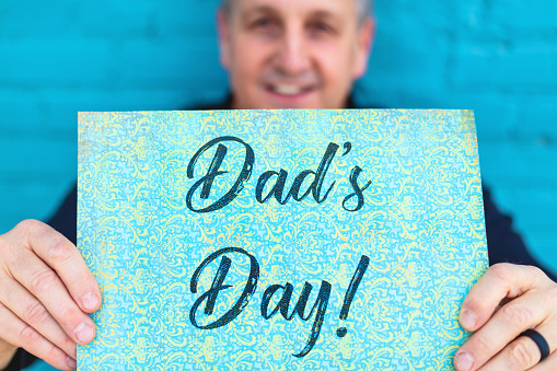Mature Male Adult and Hand-held Sign In Vibrant Outdoor Backgrounds Dad's Day (Shot with Canon 5DS 50.6mp photos professionally retouched - Lightroom / Photoshop - original size 5792 x 8688 downsampled as needed for clarity and select focus used for dramatic effect)