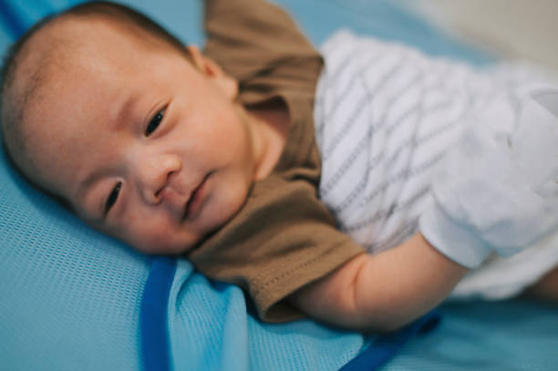 istock a baby boy with sleepy face lying down on his bed 1217518757