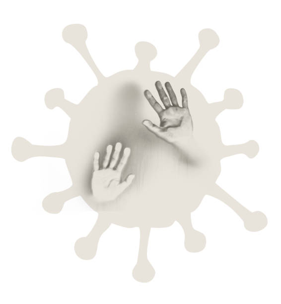 istock Hands on a window trying to come out associated with the Corona crisis 1217519782