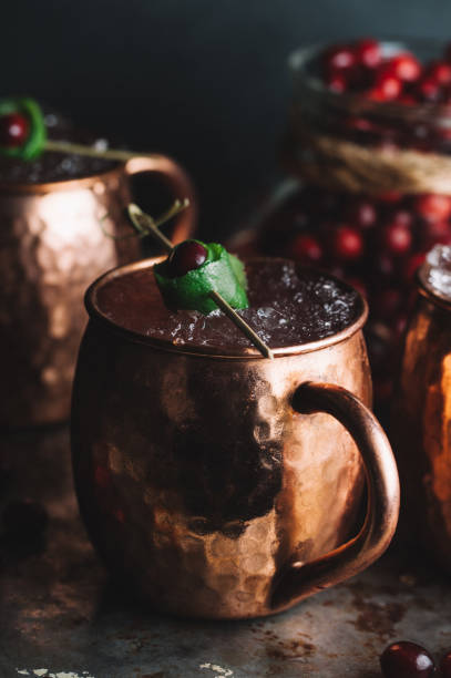istock Moscow Mule cocktails garnished with cranberries and lime 1217520585