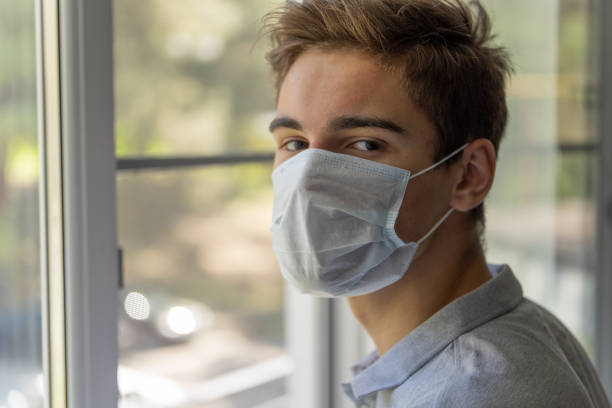istock Quarantine, student at home isolation in a protective mask. 1217525943
