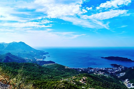 panoramic view of the Mediterranean bay from the top of the mountain. The city in the bottom of the hill right on the seashore. Landscape background
