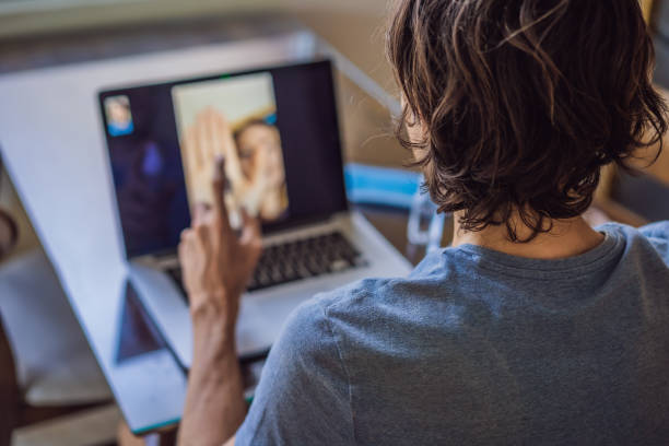 istock Coronavirus. Man in quarantine for coronavirus wearing protective mask. She's working from home and using video call. Video conference 1217526429