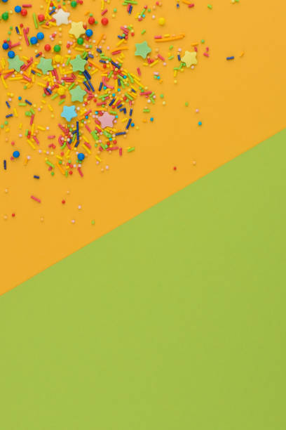 istock Decorative sprinkles border on yellow. Copy space. 1217527547