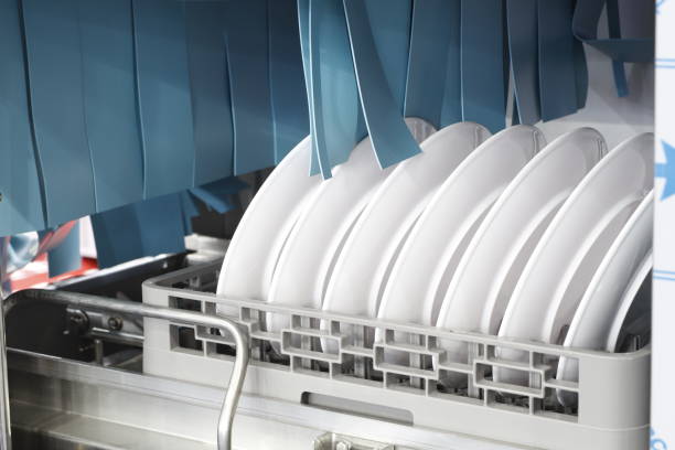 The automatic dishwasher with white clean dishes in basket The automatic dishwasher with white clean dishes in basket .For restaurant. Business industrial background dishwasher stock pictures, royalty-free photos & images