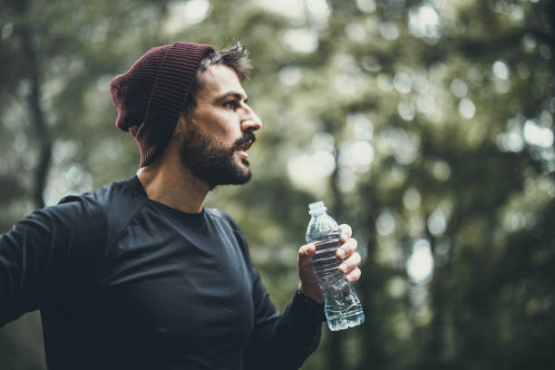 istock Athletic man having a water break in nature. 1217527739