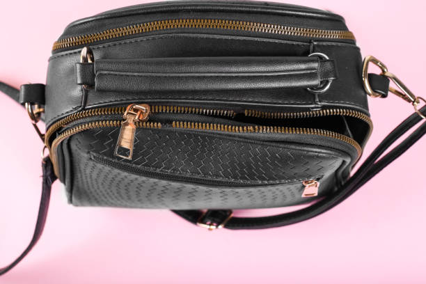 istock broken zipper on a woman's bag, top view, colorful background 1217532517