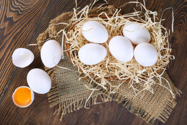 istock Fresh farm eggs on a wooden rustic background 1217532523