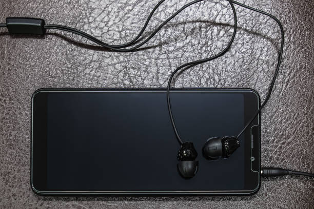 istock Smartphone and earphones placed on leather floor 1217532716