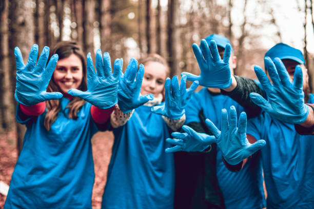 istock Friends Showing Their Gloves After Cleaning Forest From Garbage 1217533404