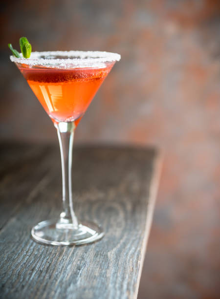 istock Red cocktail with bloody oranges in martini glass on the rustic background 1217536181