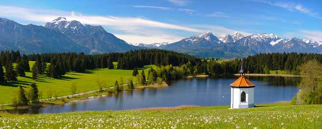 panoramic landscape with lake and mountain range in Bavaria, Germany