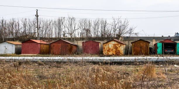 Row of garages for rent with different doors, black and white image