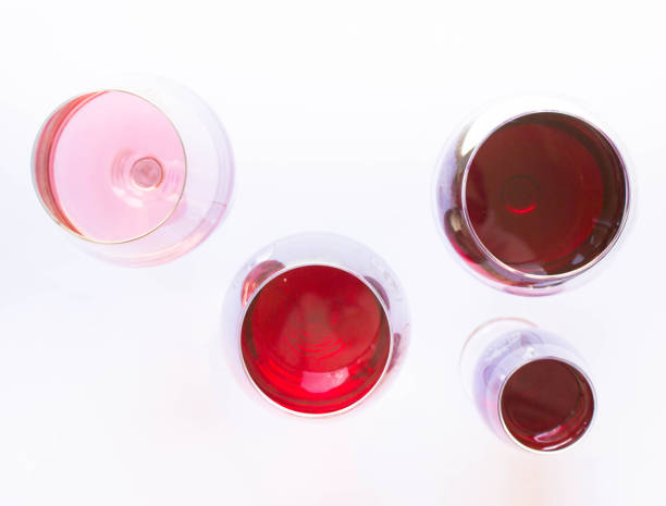 istock Four glasses of wine: red and pink on white background with sparkling shadows. Top view. Free copy space. 1217538135