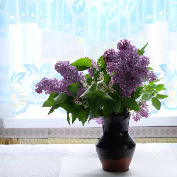 istock Lilac bouquet in a ceramic vase on the table. 1217540638