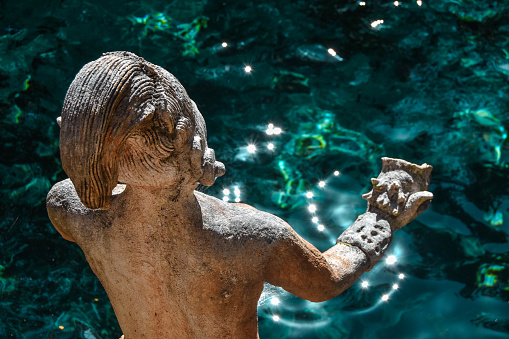 Statue in Zacil-Ha Cenote, Quintana Roo, Mexico - 12 February, 2019: \nMayan statue that protects the crystal clear waters of the Zacil-Ha cenote. Zacil-Ha Cenote located in the state of Quintana Roo, 8 kilometers from the town of Tulum, on federal highway 109, destined for the Coba Archaeological Zone.